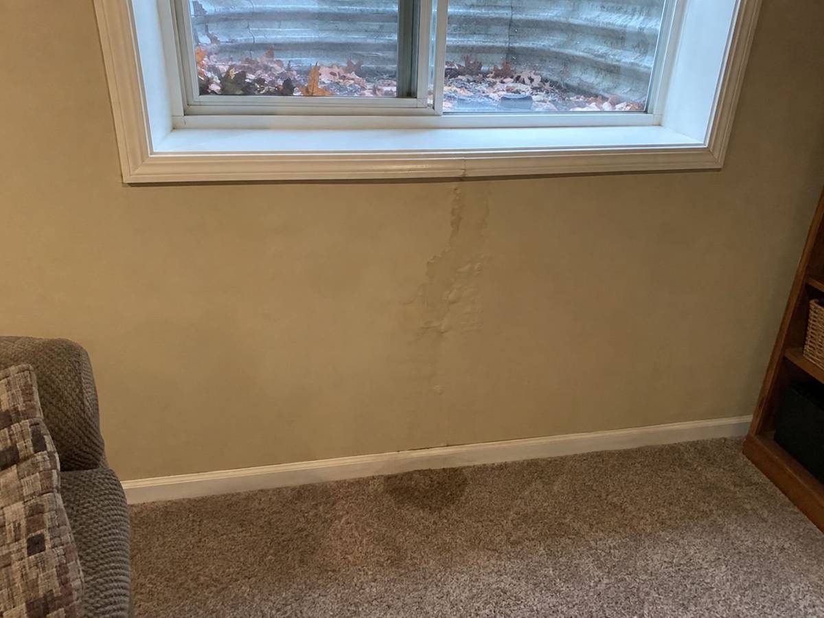 Water stain on drywall below a basement window
