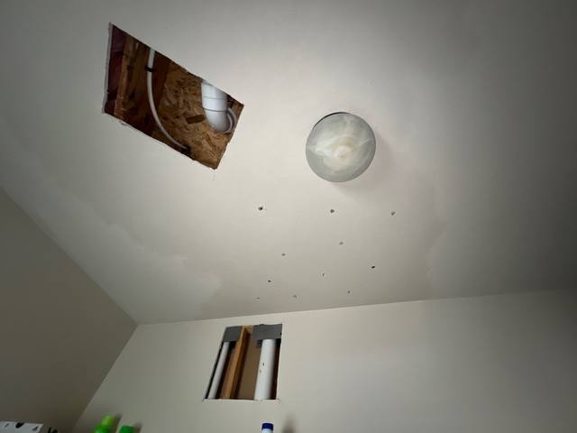 Laundry room ceiling opened to dry after a supply line leak in Lee’s Summit, MO