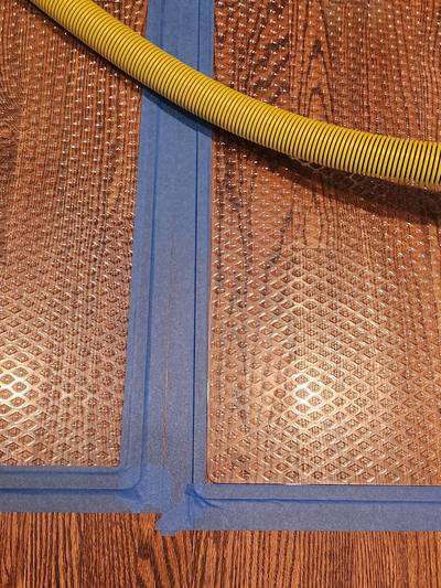 Drying mats taped to wet hardwood flooring in Overland Park, KS