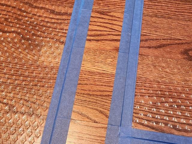 Drying panels taped over wet hardwood flooring in Overland Park, KS