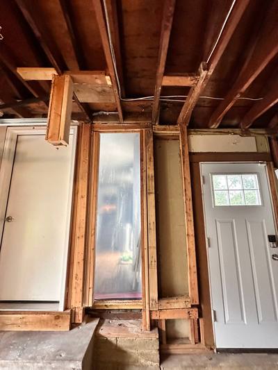 Interior wall opened around a window and door to dry wet framing in Overland Park, KS