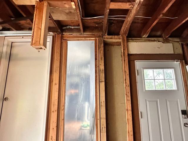 Wall opened around a window so the framing could dry before repairs in Overland Park, KS