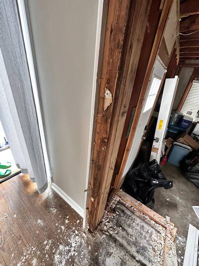 Open stud bay next to a window where moisture testing found water inside the wall, Overland Park, KS