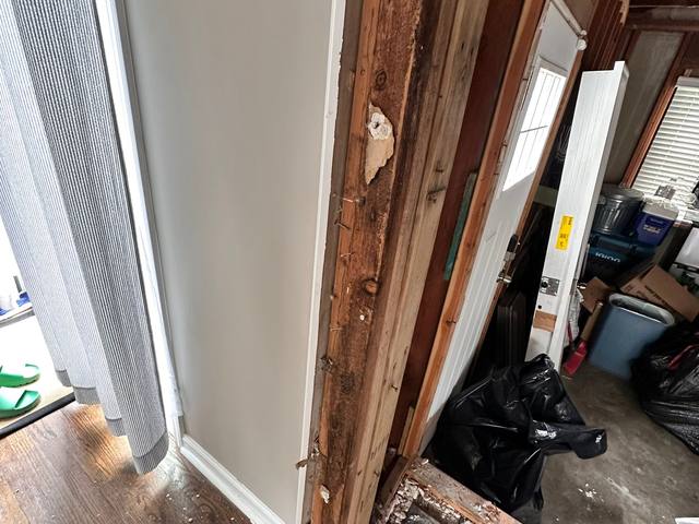 Open wall cavity beside a window where moisture testing found water, Overland Park, KS